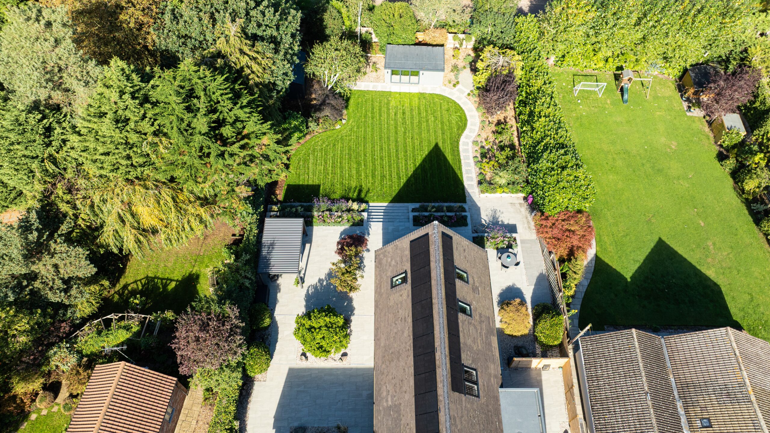 Drone footage of Pent Haus garden room in large garden with house